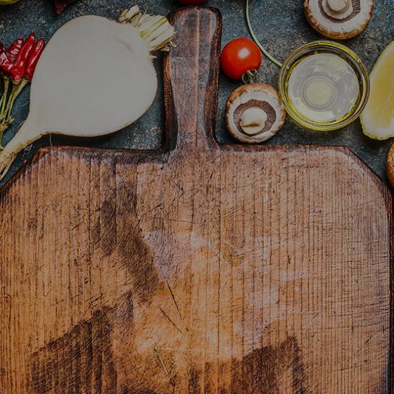 chopping board with cooking ingredients around it